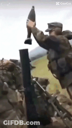 A Soldier Is Holding A Bottle In His Hand While Another Soldier Holds A Gun GIF