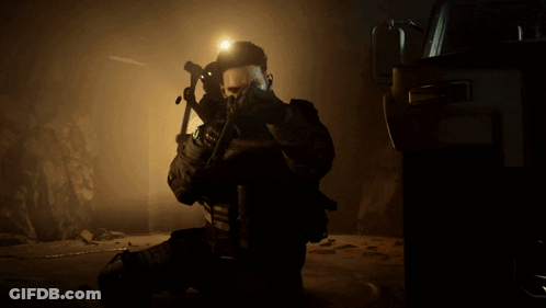 A Soldier Is Kneeling Down And Holding A Gun With The Number 11 On His Chest GIF