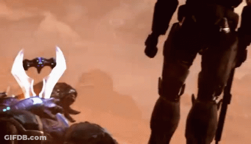 A Soldier Is Standing Next To Another Soldier With A Sword In His Hand . GIF