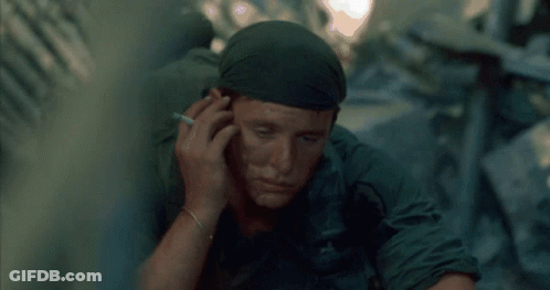 A Soldier Smoking A Cigarette And Wearing A Bandana GIF