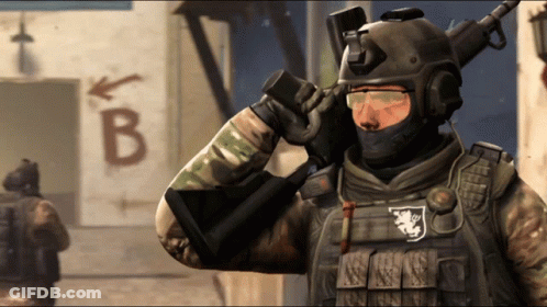 A Soldier Stands In Front Of A Sign That Says B GIF