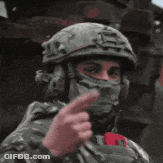 Soldier Wearing Helmet And Mask Giving Middle Finger GIF