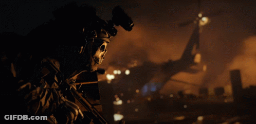 A Soldier With A Skull On His Helmet Holds A Rifle GIF