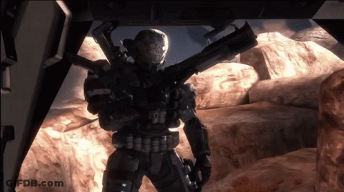 A Soldier With A Skull On His Helmet Is Holding A Rifle GIF