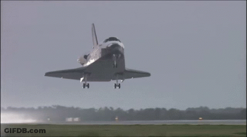 A Space Shuttle Taking Off From A Runway With Nasa On The Side GIF