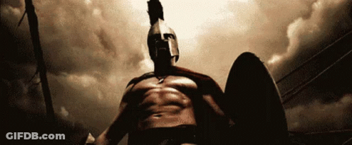 A Spartan Warrior Is Holding A Shield And Wearing A Helmet GIF