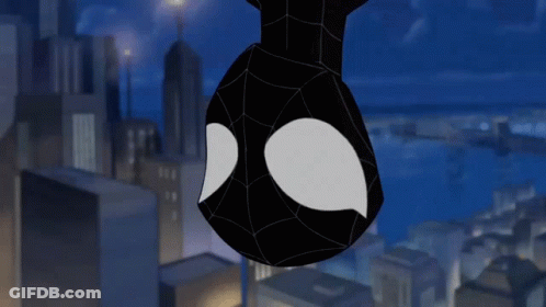 A Spider Man Hanging Upside Down In A City GIF