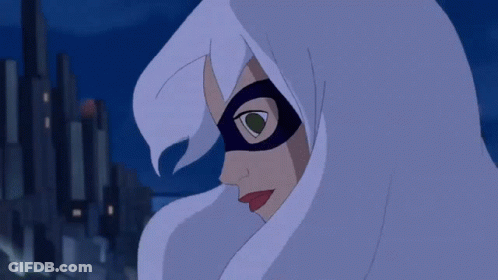 A Spider Man Hanging Upside Down In Front Of A City At Night GIF
