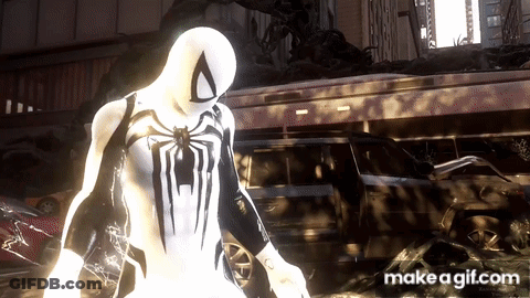 A Spider Man In A White Suit Is Standing In Front Of A Building GIF