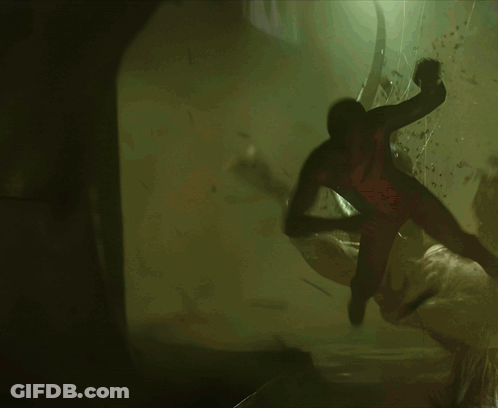 A Spider-Man Is Flying Through The Air In A Dark Room GIF