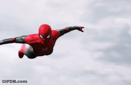 A Spider Man Is Flying Through The Air With His Arms Outstretched . GIF