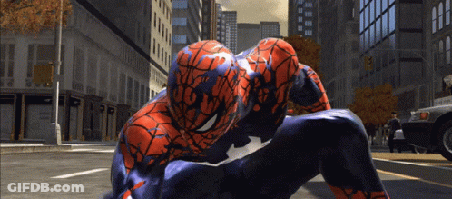A Spider Man Is Kneeling Down On The Street GIF