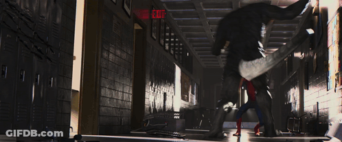 A Spider Man Is Standing In A Hallway With A Red Exit Sign GIF