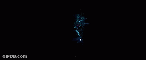 A Spider Man Is Standing In Front Of A Green Light GIF