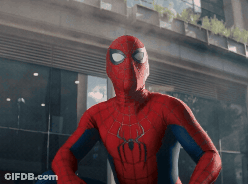 A Spider Man Standing In Front Of A Building GIF