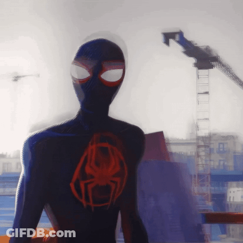 A Spider Man Standing In Front Of A Building GIF