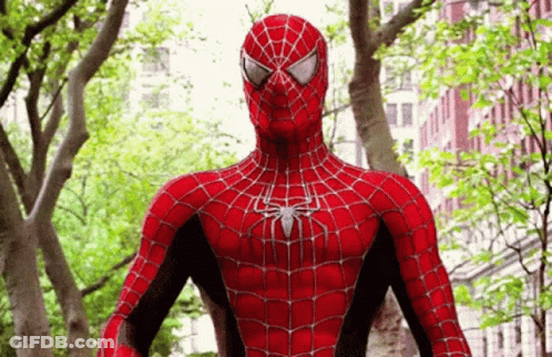 Spider Man In Front Of Trees And Buildings GIF