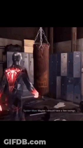 A Spider-Man Talking To Another Spider-Man In Front Of A Punching Bag That Says Naga On It GIF