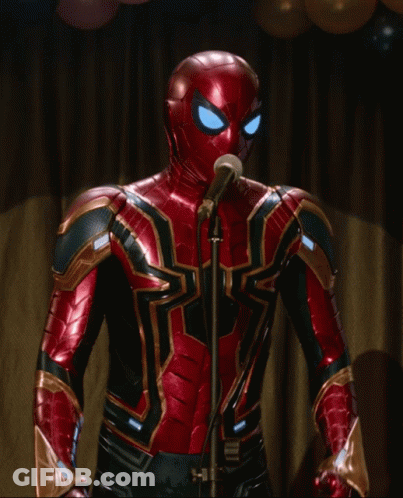 A Spiderman Is Singing Into A Microphone With Balloons In The Background GIF