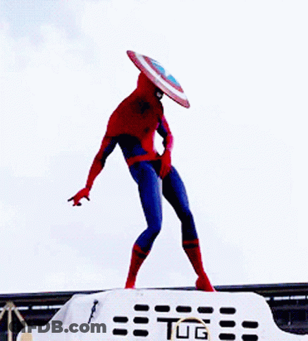 A Spiderman With A Shield On His Head Is Standing On Top Of A Tug GIF