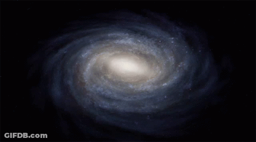 A Spiral Galaxy In A Dark Blue Sky GIF