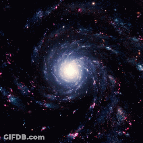 A Spiral Galaxy With A White Center Surrounded By Blue And Pink Stars GIF