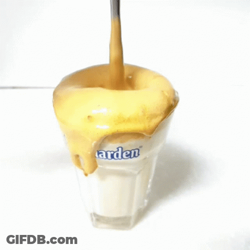 A Spoon Is Being Poured Into A Glass That Says Arden GIF