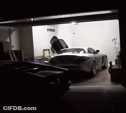 A Sports Car Is Parked In A Garage With Its Hood Up GIF