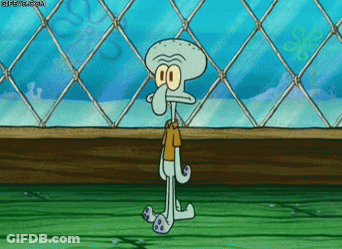 A Squidward From Spongebob Squarepants Is Standing In Front Of A Chain Link Fence . GIF