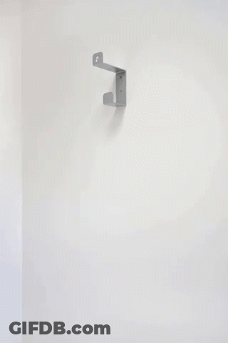 A Stack Of Black Pans Hanging On A Wall GIF