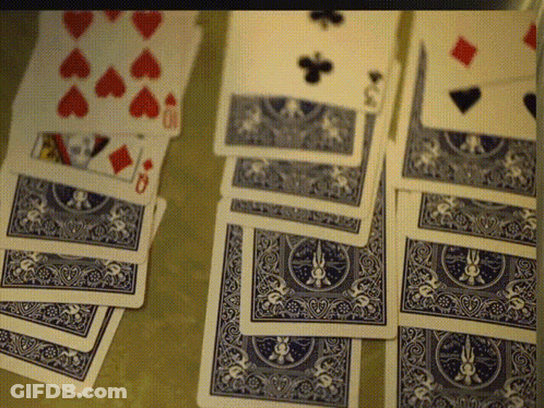 A Stack Of Blue And White Playing Cards With Hearts Diamonds And Spades On Them GIF