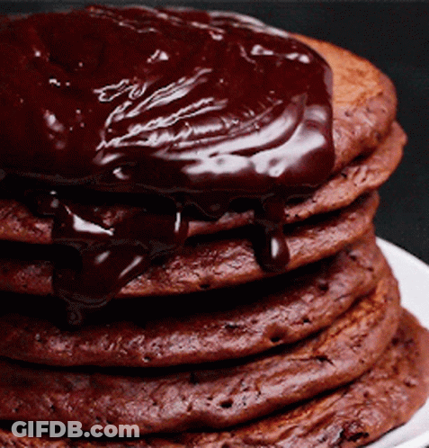 A Stack Of Chocolate Pancakes Covered In Chocolate Sauce GIF