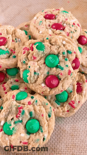 A Stack Of Cookies With M & M 'S And Sprinkles On Them GIF
