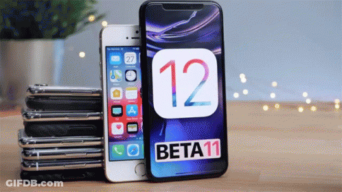 A Stack Of Iphones Sitting Next To A Beta 11 Iphone GIF