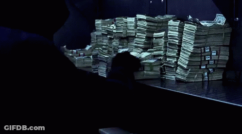A Stack Of Money On A Table With A Blue Ribbon That Says ' United States Of America ' On It GIF
