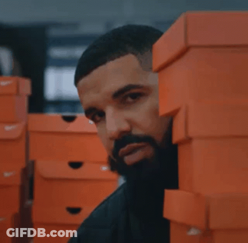 A Stack Of Orange Nike Boxes In A Store GIF