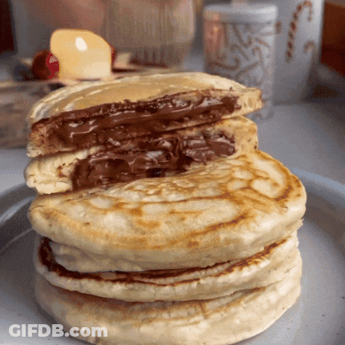 A Stack Of Pancakes With A Chocolate Filling GIF