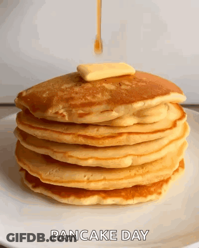 A Stack Of Pancakes With Butter And Syrup Being Poured On Them .. GIF
