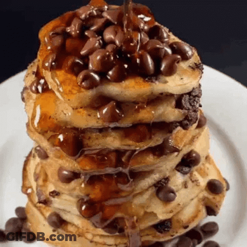 A Stack Of Pancakes With Chocolate Chips On Top On A White Plate . GIF