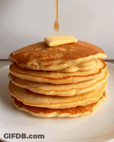 A Stack Of Pancakes With Syrup And Butter Being Poured On Top GIF