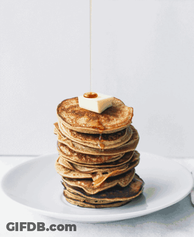 A Stack Of Pancakes With Syrup Being Poured On Top Of Them GIF