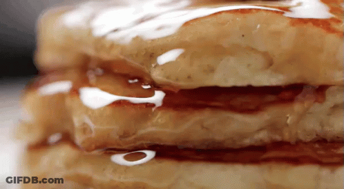 A Stack Of Pancakes With Syrup On Them GIF
