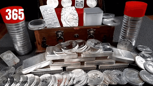 A Stack Of Silver Coins With A Jm Johnson Matthew Coin In The Background GIF