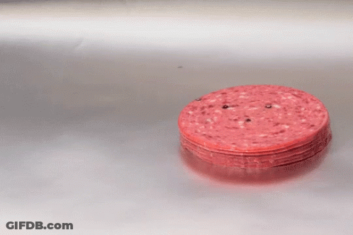 A Stack Of Sliced Sausages On A Silver Surface GIF