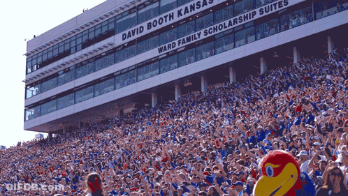 A Stadium Full Of People With The Words David Booth Kansas Ward Family Scholarship Suites GIF