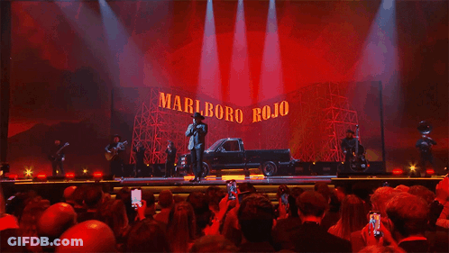 A Stage With A Truck In Front Of A Marlboro Rojo Sign GIF