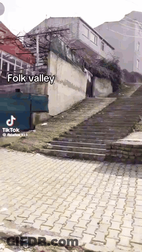 A Staircase Leading Up To A Building With The Words Folk Valley On The Bottom GIF