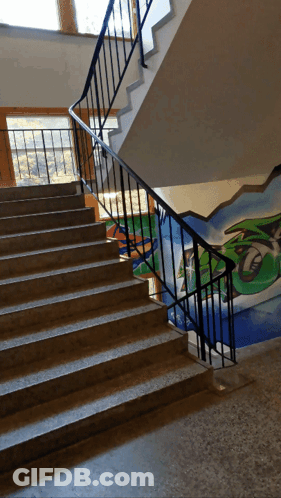 A Staircase With Graffiti On The Wall And The Letter T GIF