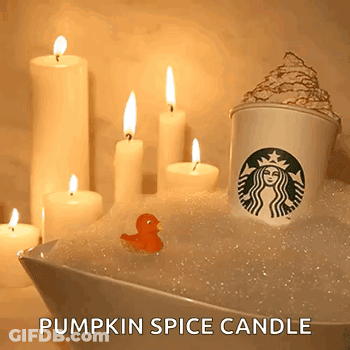 A Starbucks Cup Is In A Bathtub With Candles GIF