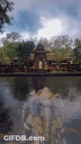 A Statue In Front Of A Building With The Letter W On It GIF